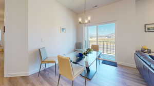 Dining area featuring an inviting chandelier and light hardwood / wood-style flooring