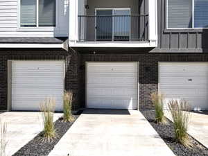 Entrance to property featuring a balcony and a garage