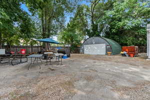 View of patio with an outdoor structure and a garage