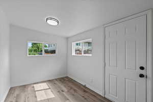 Empty room with light hardwood / wood-style flooring