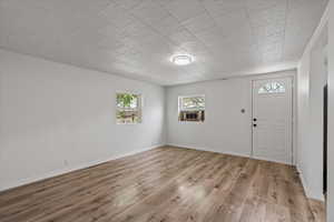 Entryway featuring cooling unit and hardwood / wood-style floors