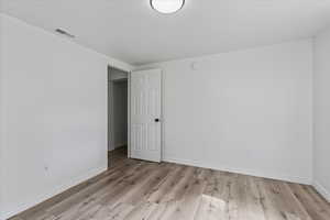 Spare room with light hardwood / wood-style flooring