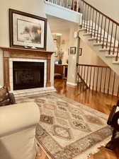 Living room with hardwood / wood-style flooring and a tile fireplace