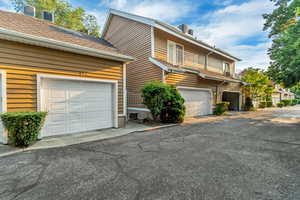 View of side of property featuring a balcony and a garage