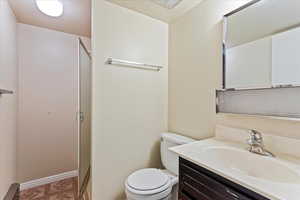 Bathroom featuring vanity, toilet, tile patterned floors, and baseboard heating