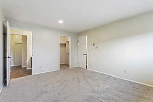 Unfurnished bedroom with a closet, carpet floors, and a spacious closet