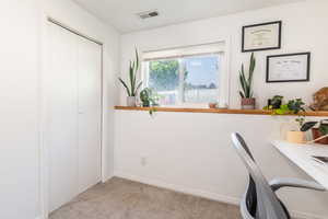 Unfurnished office with light colored carpet