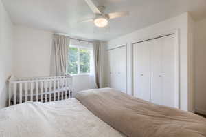 Bedroom featuring two closets and ceiling fan