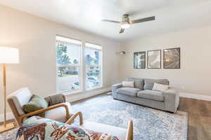 Living room featuring ceiling fan and hardwood / wood-style flooring