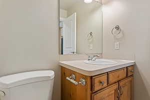 Bathroom featuring vanity and toilet