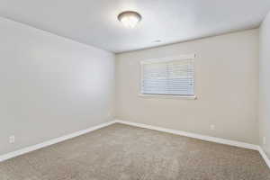 Unfurnished room with carpet floors