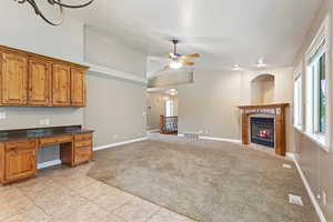 Kitchen with light tile patterned floors, ceiling fan, and vaulted ceiling