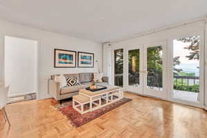 Family room adjacent to the kitchen featuring parquet floors, and french doors