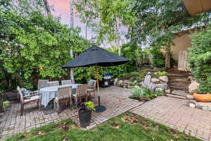 Patio terrace at dusk featuring grilling area