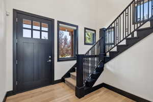 Foyer entrance featuring a high ceiling and light hardwood / wood-style flooring