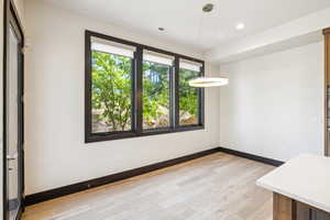 Unfurnished room with light wood-type flooring