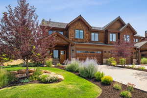 View of front of house featuring a garage and a front yard