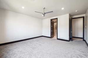 Unfurnished bedroom featuring light colored carpet and ceiling fan