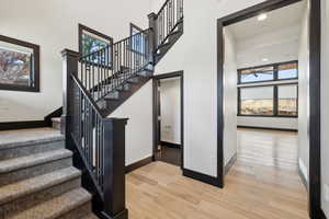 Staircase featuring light hardwood / wood-style flooring and ceiling fan