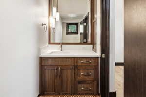 Bathroom featuring vanity and wood-type flooring