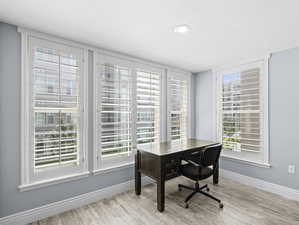 Office area with light hardwood / wood-style flooring