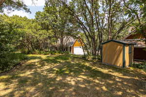 View of yard with a shed and a garage