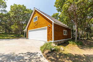 View of property exterior featuring a garage