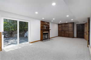 Unfurnished living room featuring light colored carpet