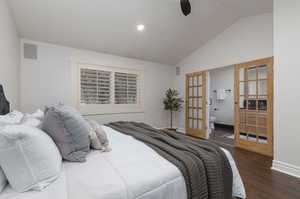 Bedroom with ensuite bath, french doors, dark hardwood / wood-style flooring, high vaulted ceiling, and ceiling fan