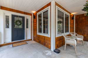 Entrance to property featuring covered porch