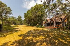 View of yard with a brand new deck