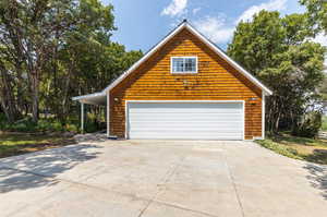 View of side of home with a garage