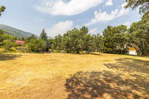 View of yard featuring a mountain view, an outdoor structure, and a garage