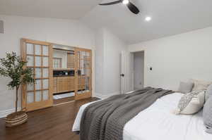 Bedroom featuring french doors, vaulted ceiling, dark hardwood / wood-style flooring, and ceiling fan