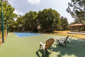 View of tennis court with a gazebo