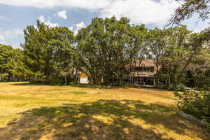 View of yard with a garage and an outdoor structure