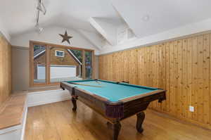 Playroom featuring lofted ceiling, light hardwood / wood-style flooring, billiards, and rail lighting