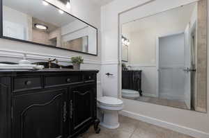 Bathroom with vanity, tile patterned flooring, and toilet