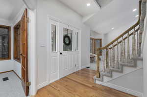 Foyer entrance with wood-type flooring