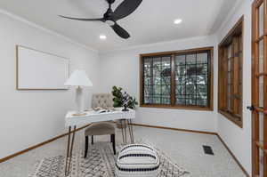 Carpeted office space featuring crown molding and ceiling fan