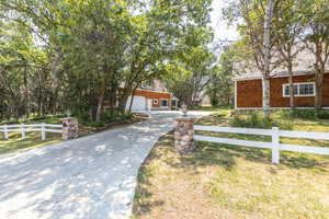 View of front of property featuring a garage and a front lawn