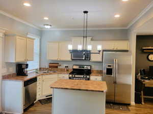 Kitchen with stainless steel appliances. All appliances stay with the home.
