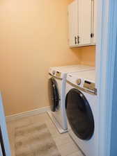 Laundry room with storage. Newer washer and dryer included.