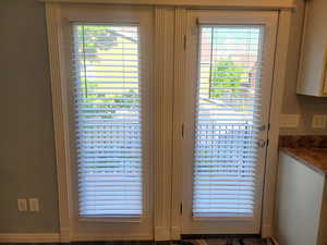 French doors leading to balcony off of the kitchen