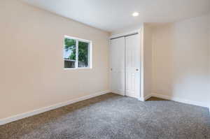 Bedroom with carpet and a closet