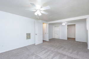 Unfurnished bedroom with light carpet, a closet, and ceiling fan