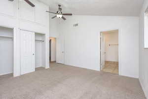 Unfurnished bedroom featuring light carpet, a textured ceiling, and ceiling fan