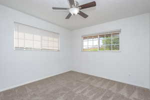 Unfurnished room featuring carpet flooring and ceiling fan