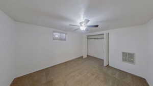 Unfurnished bedroom with light colored carpet, a closet, and ceiling fan