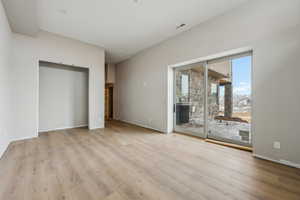 Unfurnished bedroom featuring access to exterior and light hardwood / wood-style floors